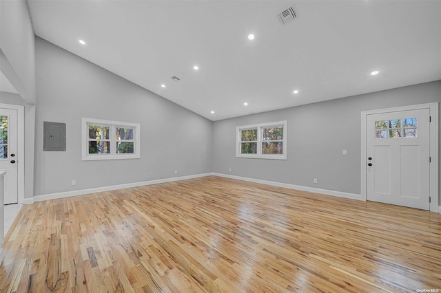 entrance foyer with electric panel, light hardwood / wood-style flooring, and high vaulted ceiling