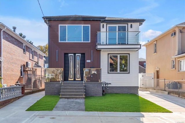 view of front of home featuring a balcony