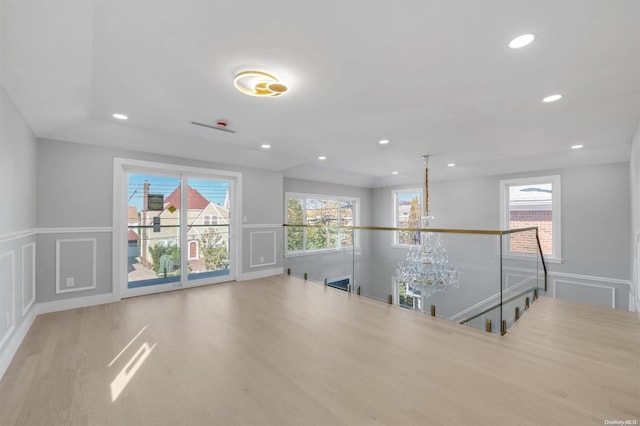 interior space featuring an inviting chandelier and light wood-type flooring