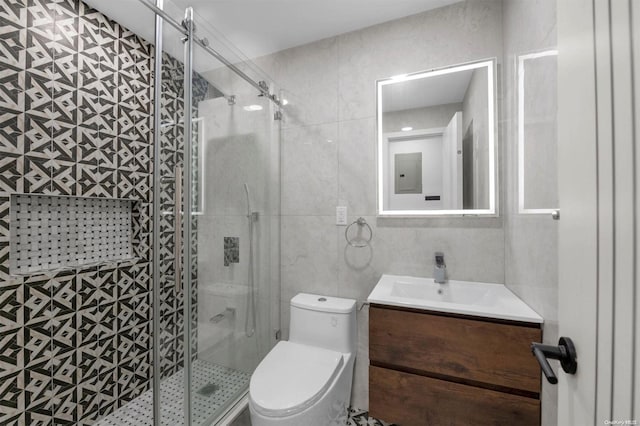 bathroom featuring vanity, a shower with door, tile walls, electric panel, and toilet