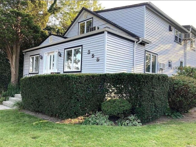 view of home's exterior with a yard