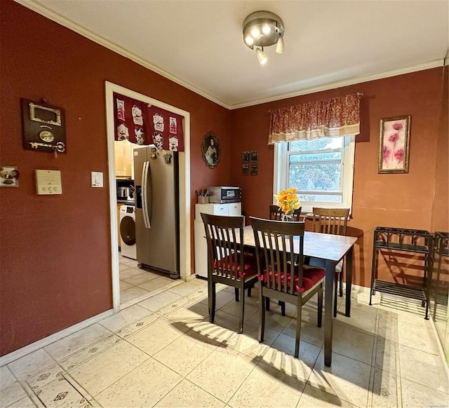 dining area with crown molding and washer / dryer