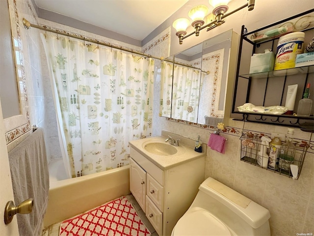 full bathroom with vanity, shower / bathtub combination with curtain, toilet, and tile walls