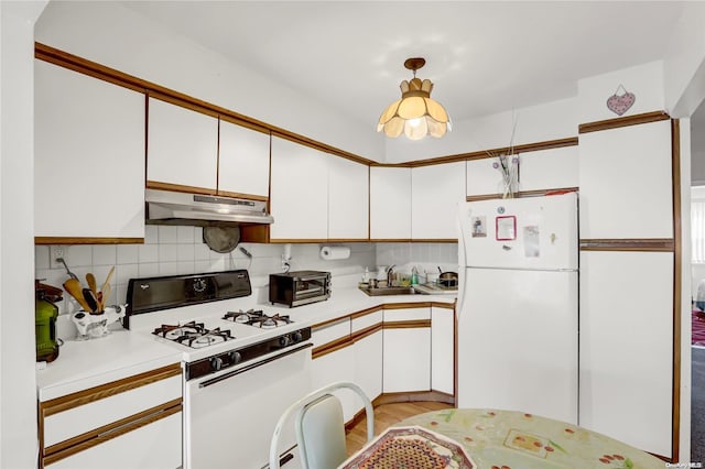 kitchen with white appliances, white cabinets, sink, light hardwood / wood-style flooring, and tasteful backsplash