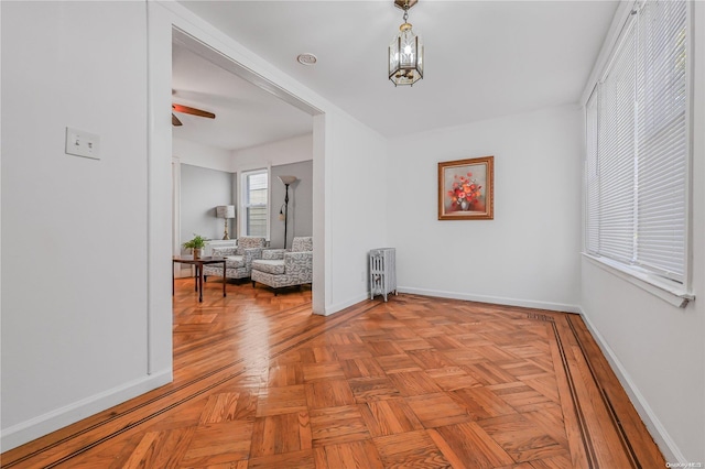 hall featuring light parquet flooring and radiator