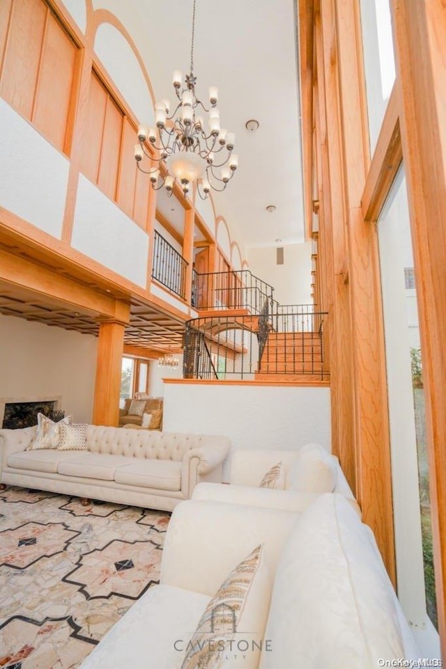 living room featuring a high ceiling and a notable chandelier