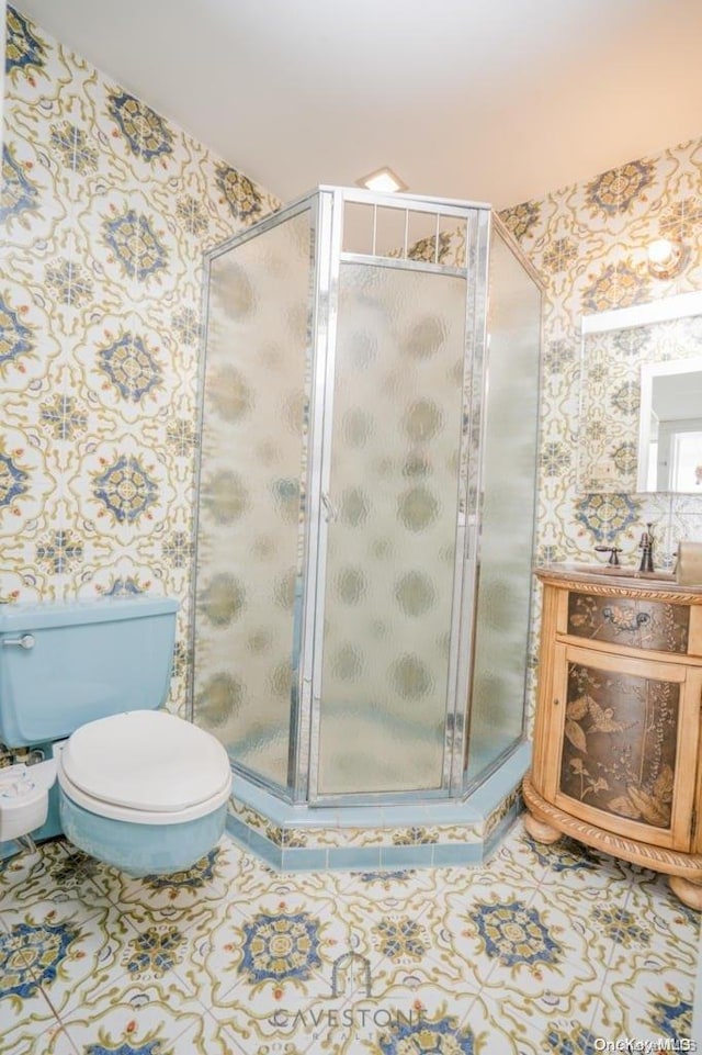 bathroom featuring tile patterned floors, toilet, and an enclosed shower