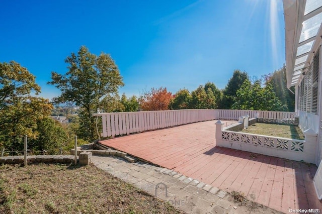 wooden terrace with a lawn