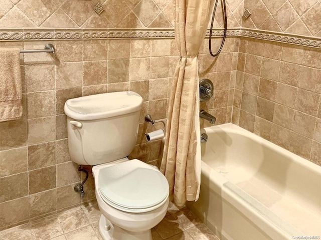 bathroom featuring tile patterned flooring, shower / bath combination with curtain, toilet, and tile walls