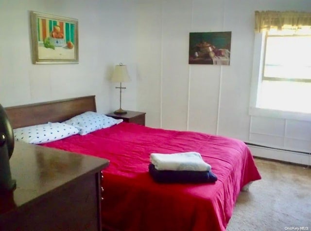 bedroom featuring carpet floors and a baseboard heating unit