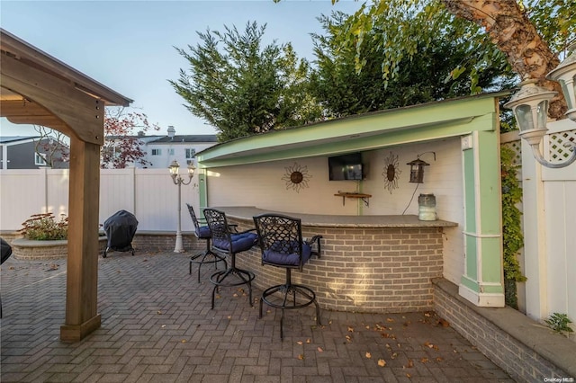 view of patio featuring a grill and exterior bar