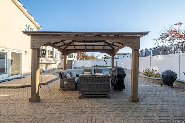 view of patio featuring a gazebo, an outdoor living space, and grilling area