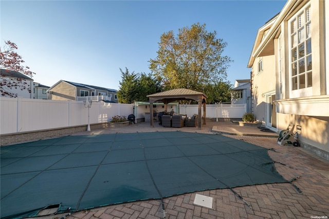 view of swimming pool with a gazebo and a patio area