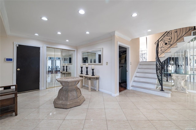 foyer entrance with light tile patterned floors, plenty of natural light, and ornamental molding