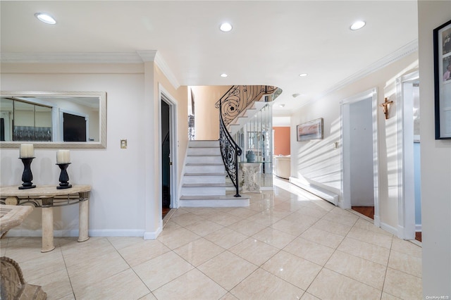 entryway featuring crown molding and light tile patterned floors