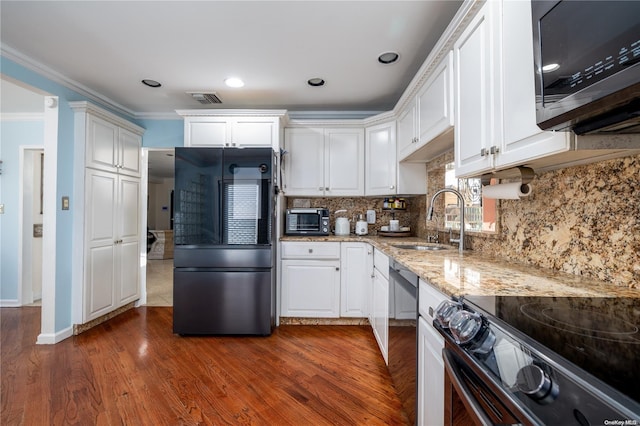 kitchen featuring sink, white cabinetry, stainless steel appliances, and dark wood-type flooring