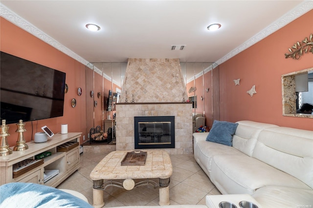 living room with a tile fireplace and light tile patterned floors