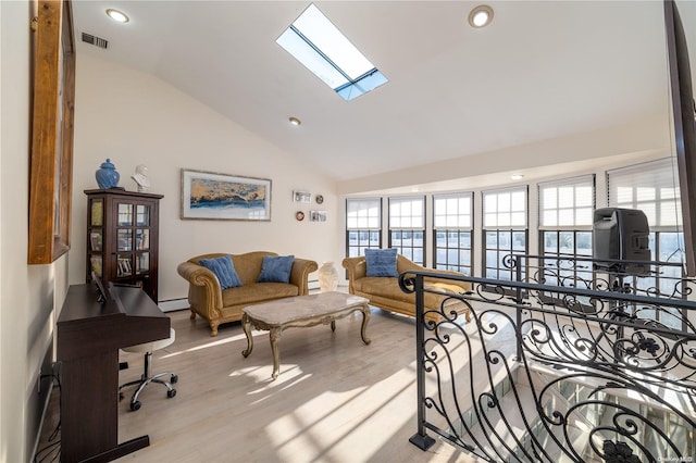 interior space featuring high vaulted ceiling, a skylight, light hardwood / wood-style flooring, and baseboard heating