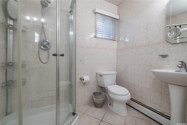 bathroom with tile patterned floors, a baseboard radiator, tile walls, and toilet