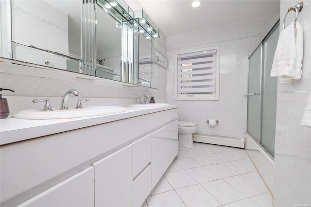 bathroom featuring walk in shower, baseboard heating, toilet, vanity, and tile walls