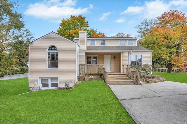 view of front of house featuring covered porch and a front yard