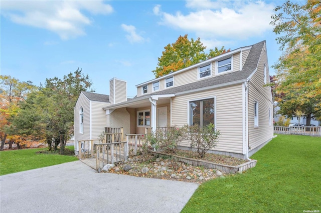 view of front of home with a porch and a front lawn