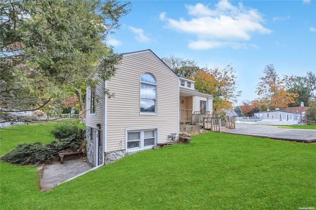 view of side of home featuring a yard