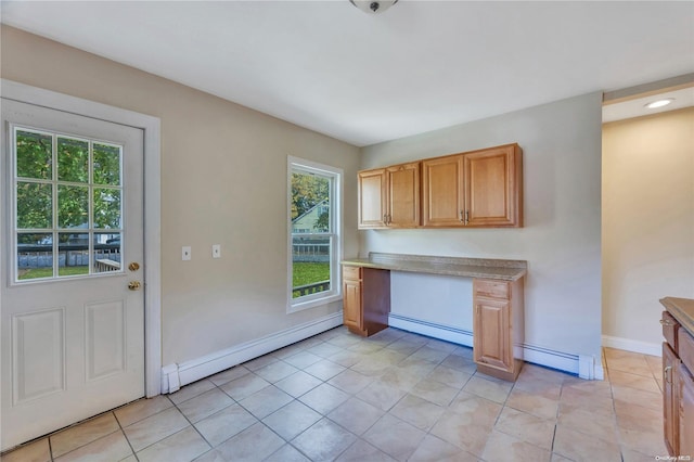 kitchen with light tile patterned floors and baseboard heating