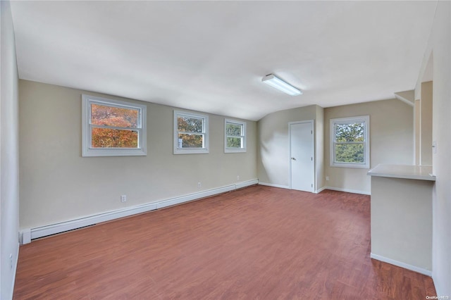 unfurnished room featuring baseboard heating and hardwood / wood-style flooring