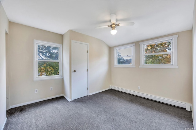 unfurnished bedroom with multiple windows, ceiling fan, carpet floors, and a baseboard heating unit