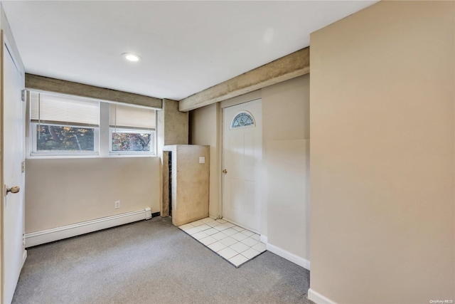 carpeted spare room featuring baseboard heating