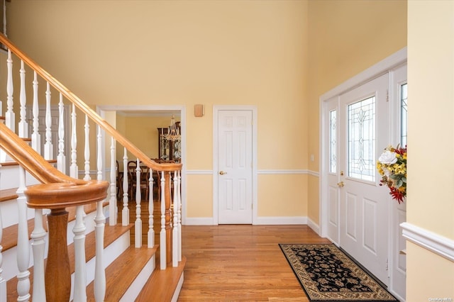 foyer with light hardwood / wood-style floors and a high ceiling