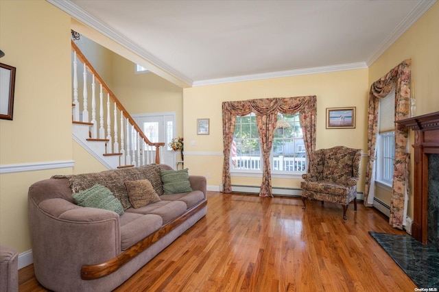 living room featuring ornamental molding and light hardwood / wood-style flooring