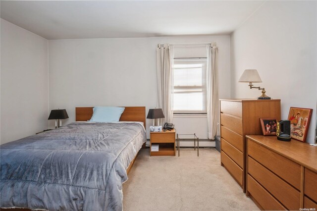 carpeted bedroom with a baseboard heating unit