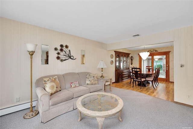 living room featuring a baseboard radiator and light hardwood / wood-style flooring