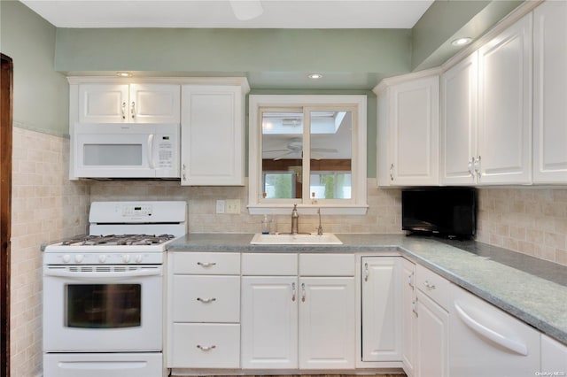 kitchen featuring light stone countertops, sink, white cabinets, and white appliances