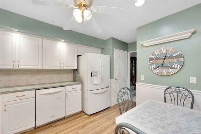 kitchen with white cabinetry, ceiling fan, backsplash, light hardwood / wood-style floors, and white appliances