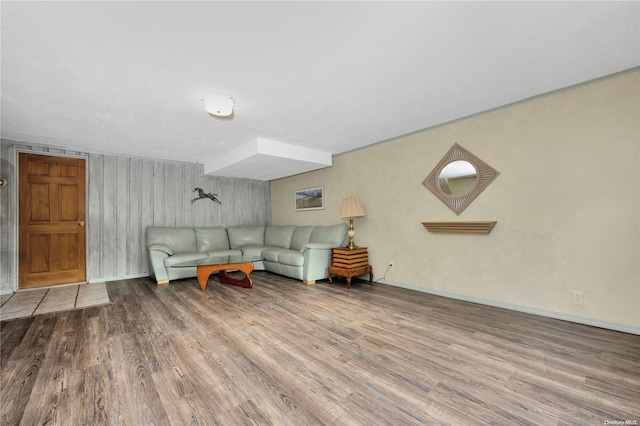 living room with wood walls and wood-type flooring