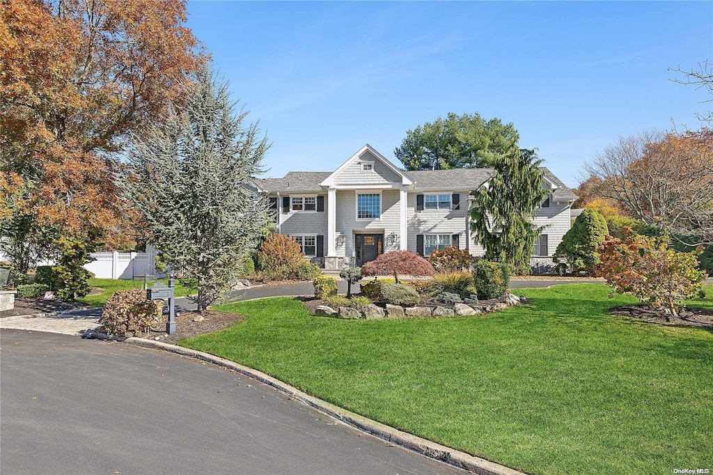 greek revival inspired property with a front lawn