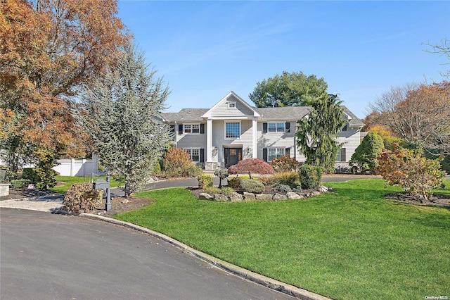 greek revival inspired property with a front lawn