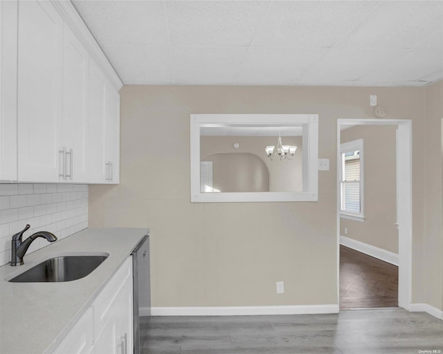 kitchen featuring sink, white cabinets, and light hardwood / wood-style flooring