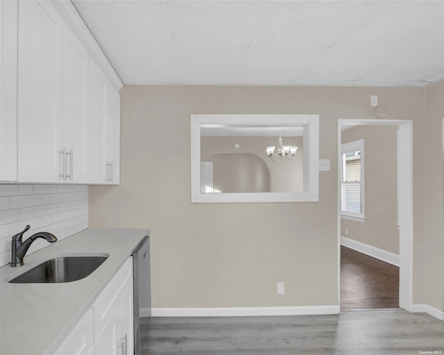 94-51 226th St, Floral Park, NY 11001 - kitchen featuring a sink, light countertops, wood finished floors, and white cabinets