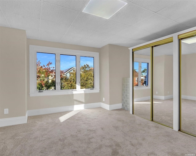 unfurnished bedroom with multiple closets and carpet floors