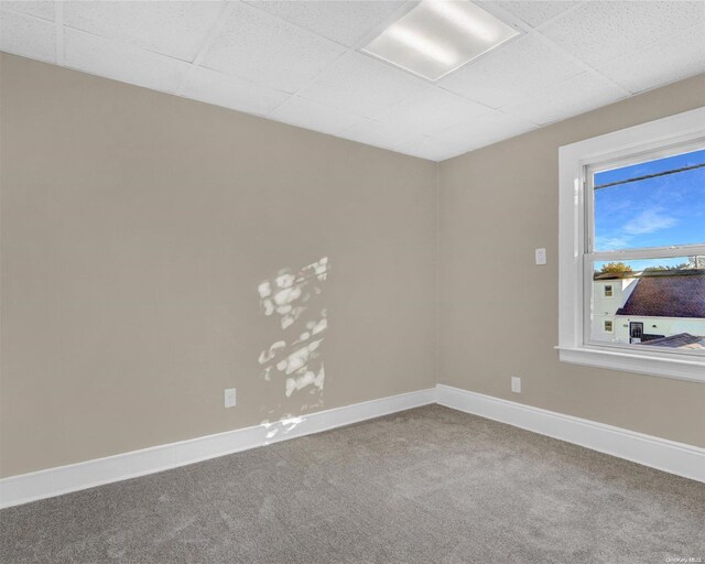 94-51 226th St, Floral Park, NY 11001 - empty room featuring a drop ceiling, carpet, and baseboards