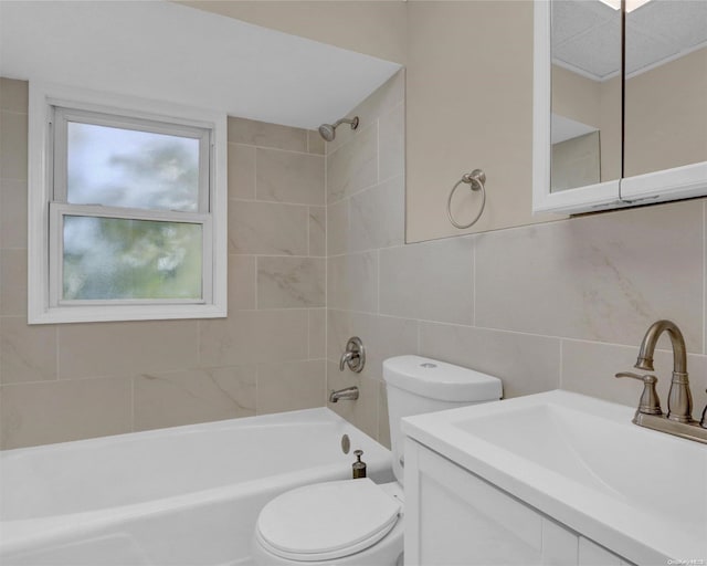 full bathroom with decorative backsplash, vanity, tiled shower / bath combo, tile walls, and toilet