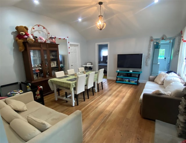 dining area with vaulted ceiling and hardwood / wood-style floors