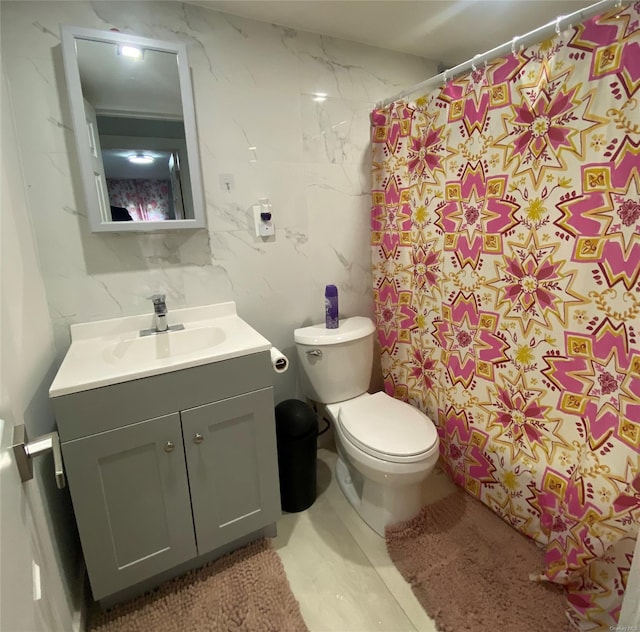 bathroom with toilet, vanity, tile walls, and a shower with curtain