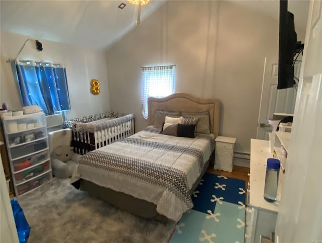 bedroom with lofted ceiling and a baseboard radiator