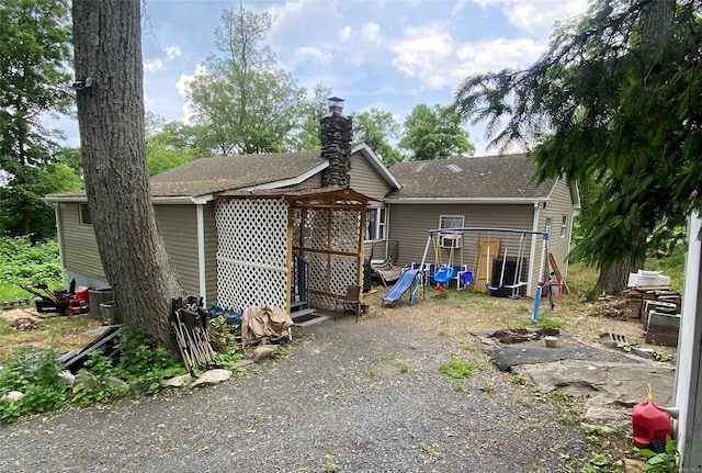 rear view of house with a playground