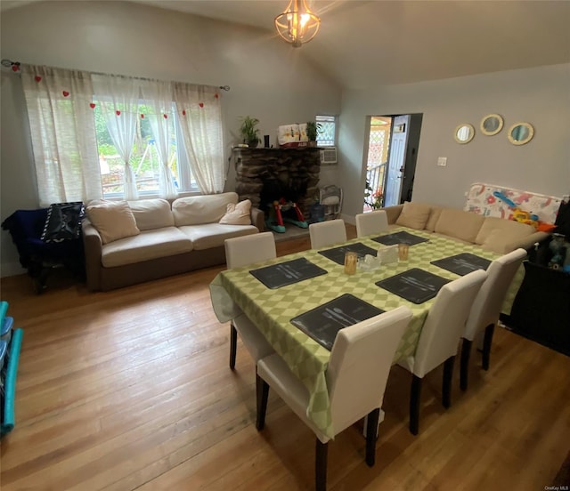 dining space with light wood-type flooring and a fireplace